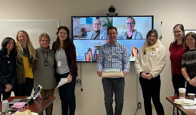 Maple Maternity Clinic team poses for a photo in front of a white board and a Zoom meeting screen